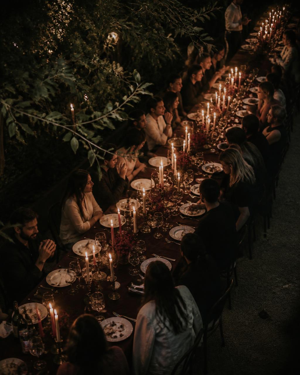 Candlelit long-table dinner outdoors